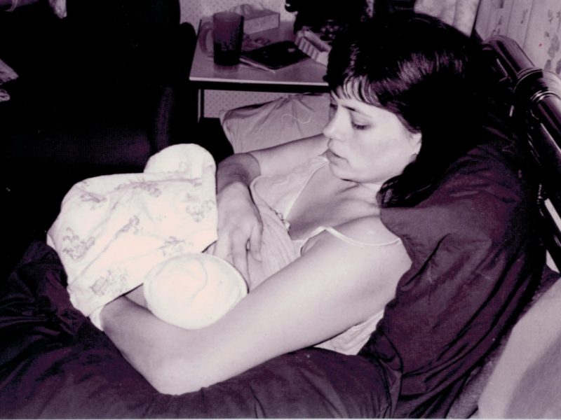 woman breastfeeding her newborn baby