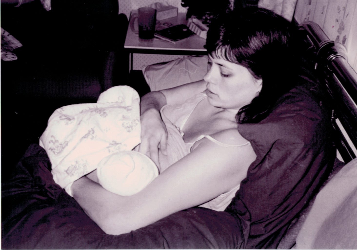 woman breastfeeding her newborn baby