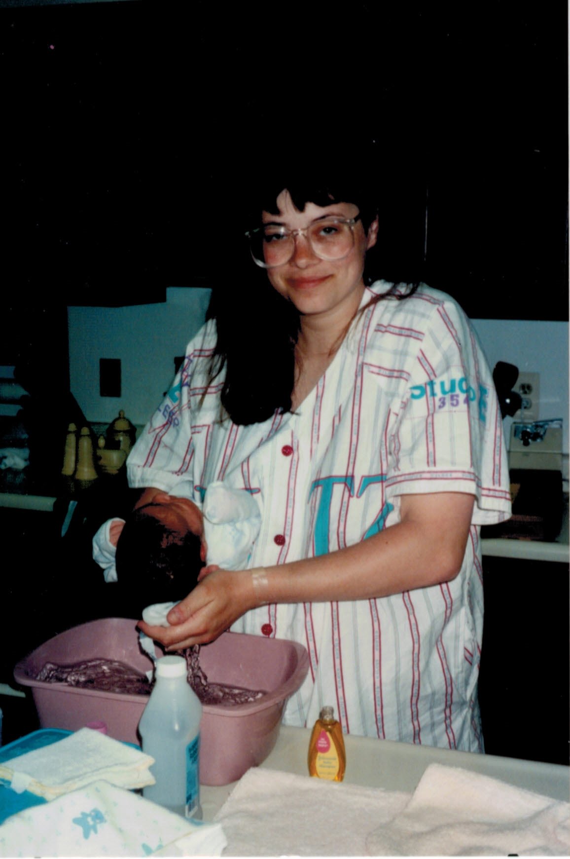 woman giving her newborn a bath