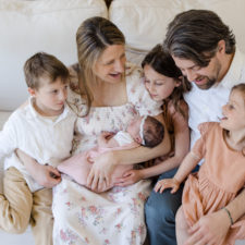 Happy-family-gazing-at-newborn-baby