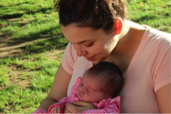 Mom holding newborn baby 