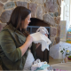 woman opening gifts at a baby shower
