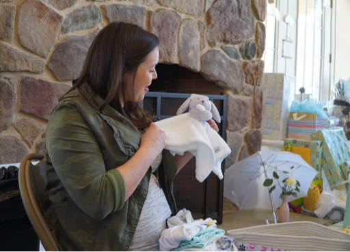 woman opening gifts at a baby shower