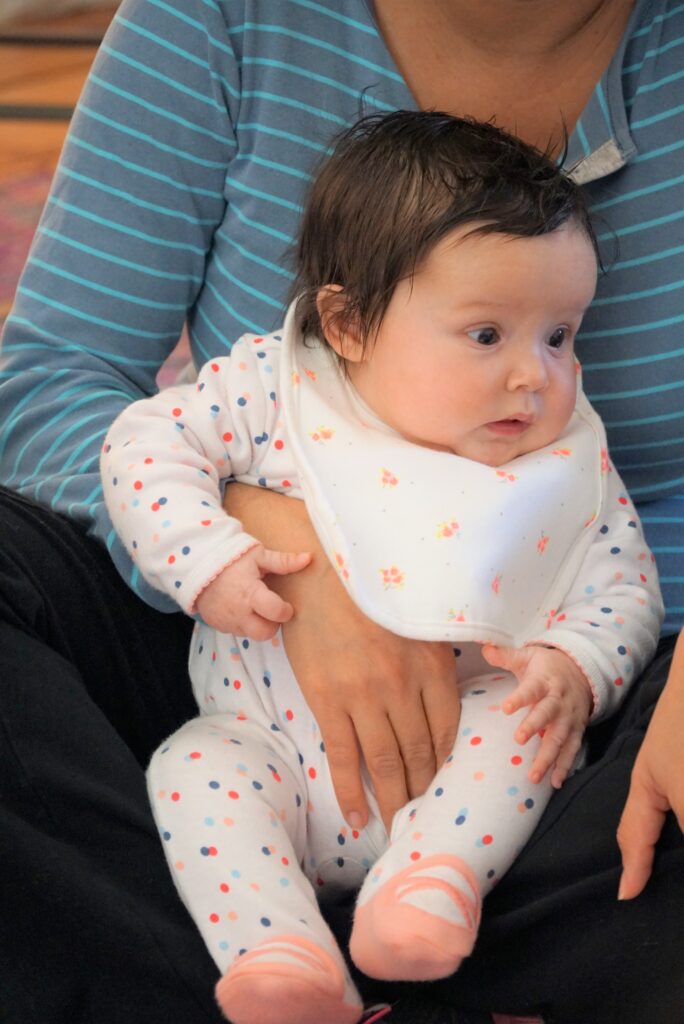 baby being held by mom at midwives of new jersey lactation circle