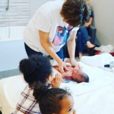 Midwife checking newborn baby after birth