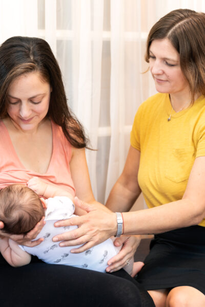 lactation-consultant-working-with-a-new-mom-and-newborn