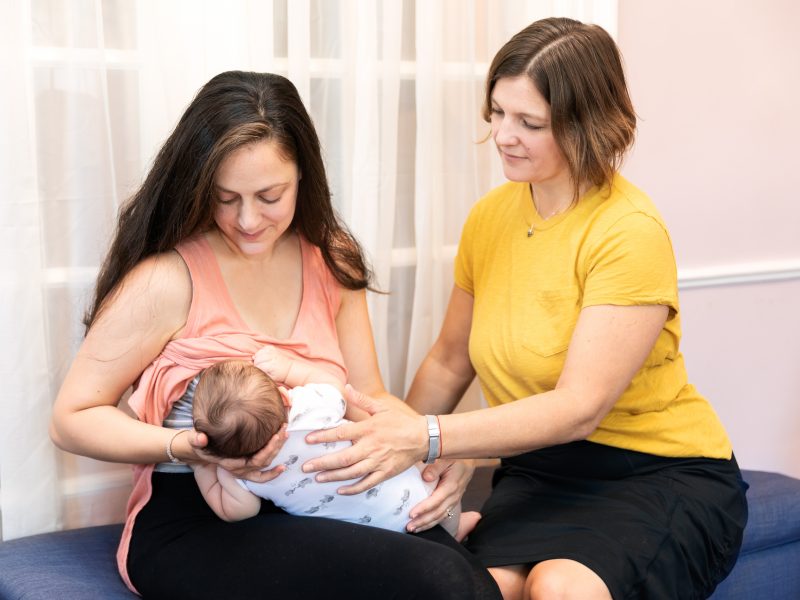 lactation-consultant-working-with-a-new-mom-and-newborn