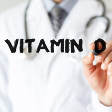 Doctor-writing-word-Vitamin-D