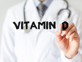 Doctor-writing-word-Vitamin-D