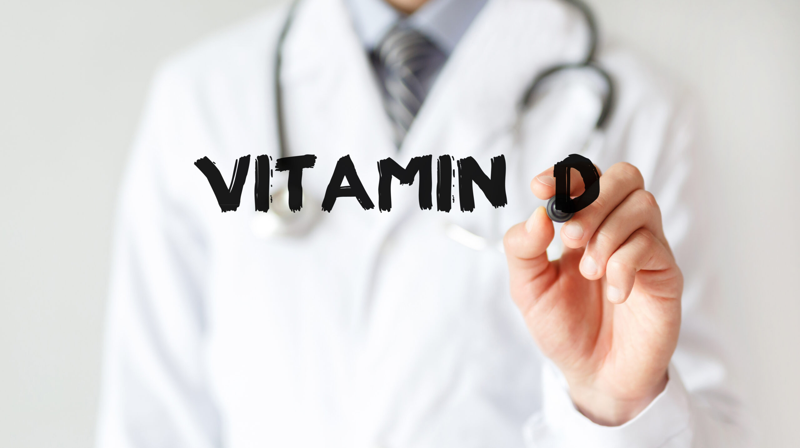 Doctor-writing-word-Vitamin-D