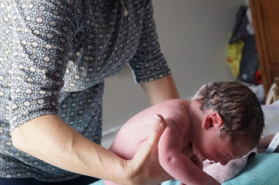 Midwife holding a baby
