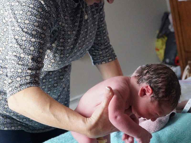 Midwife holding a baby