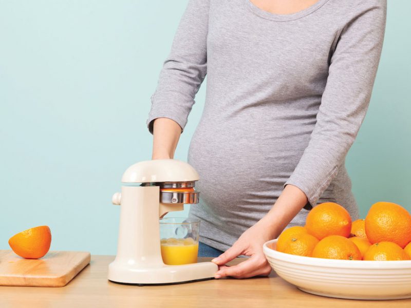 Expecting mother makes natural orange juice