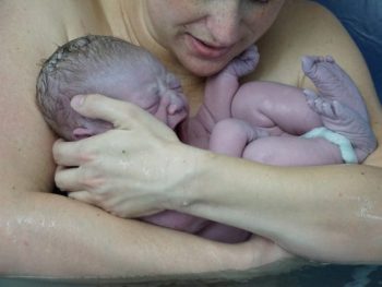 mom holding newborn after waterbirth