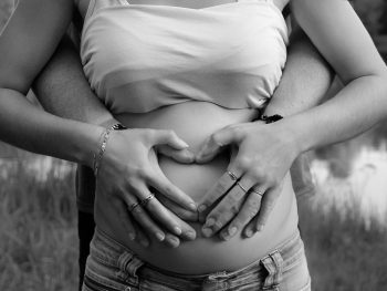 Hands on pregnant mother's belly