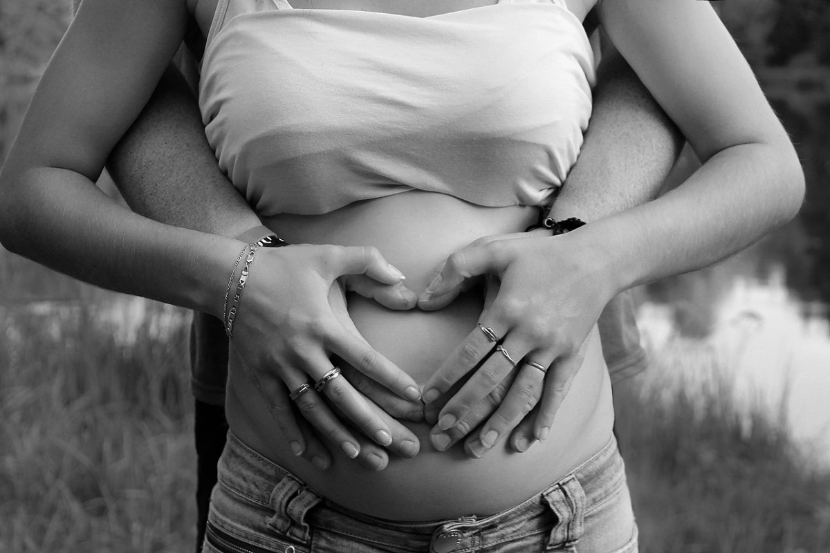 Hands on pregnant mother's belly