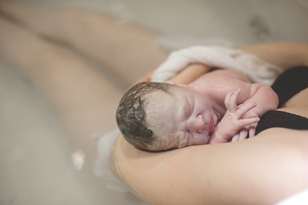 waterbaby being held by mom midwives of nj