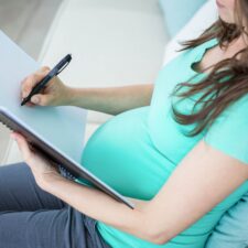 pregnant woman writing