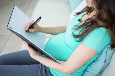 pregnant woman writing