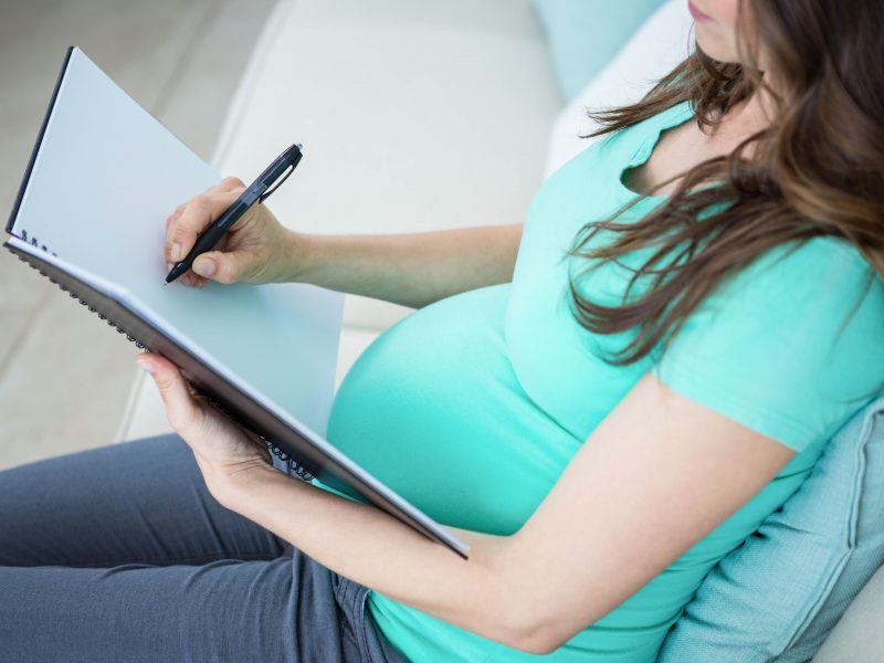 pregnant woman writing