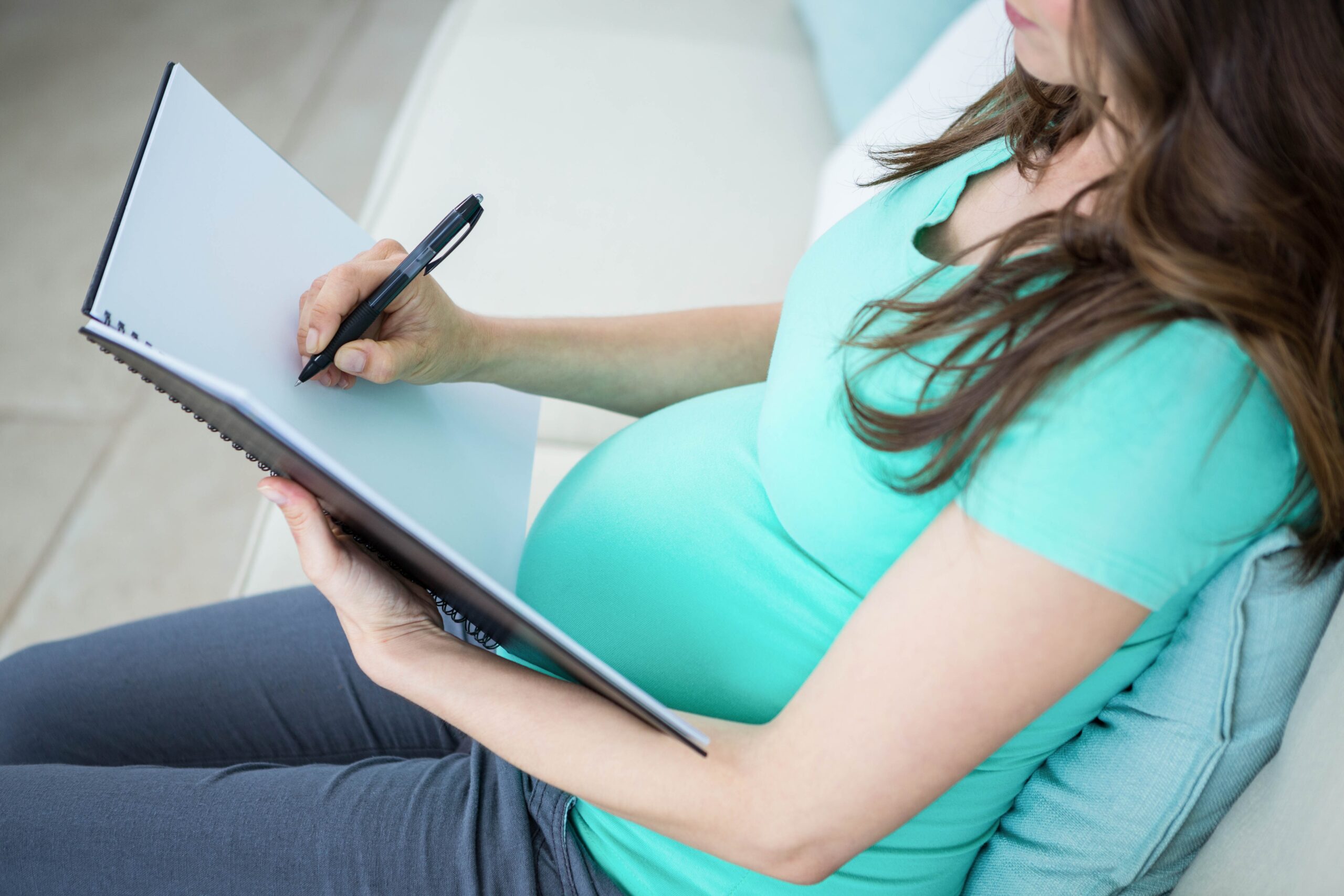 pregnant woman writing